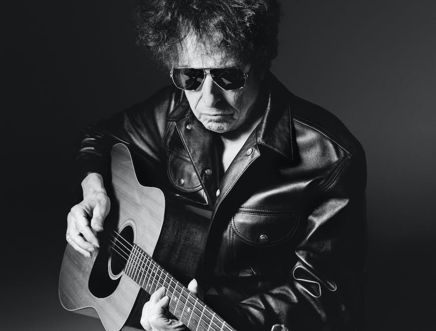 Bob Dylan wears black leather jacket, black leather pants and sunglasses.