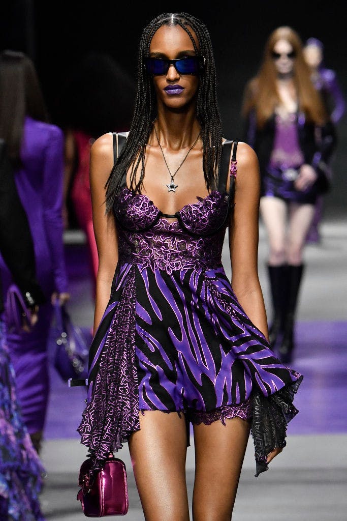 A model in a purple striped dress.