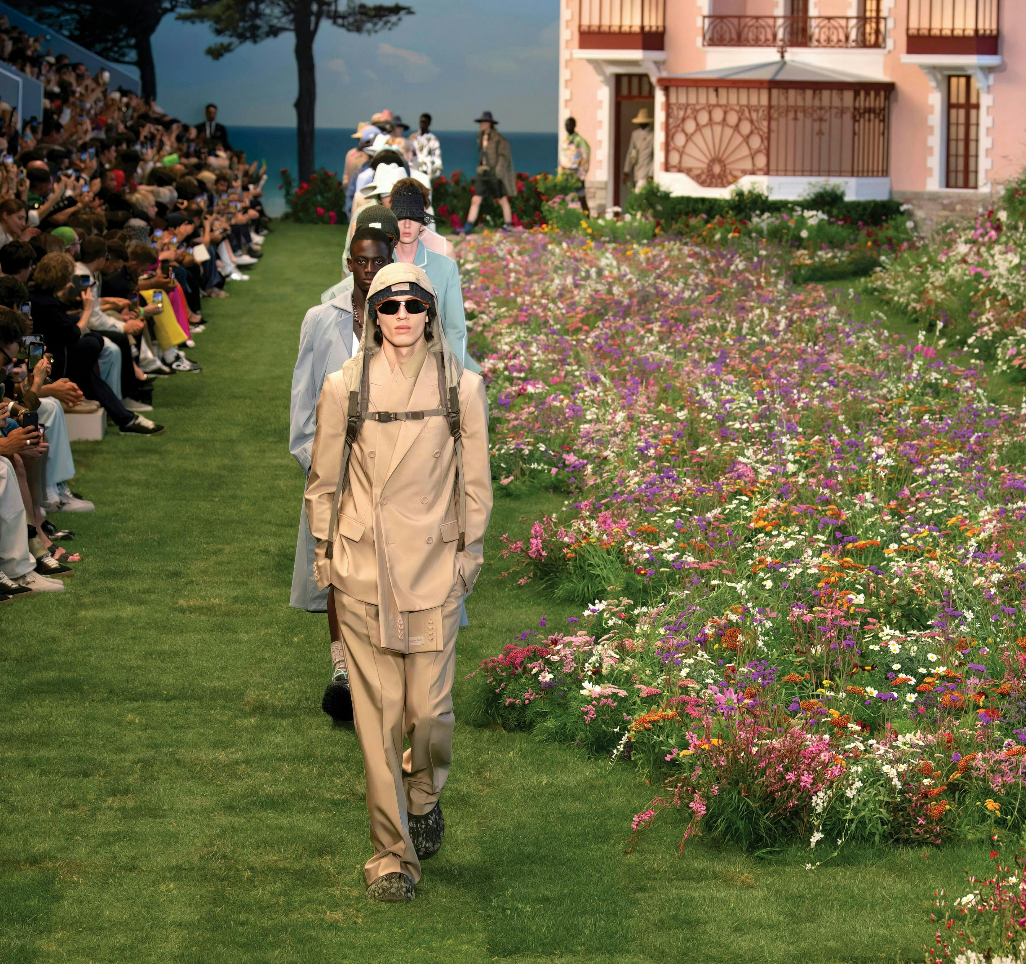 Dior Men's Collection runway on green grass.