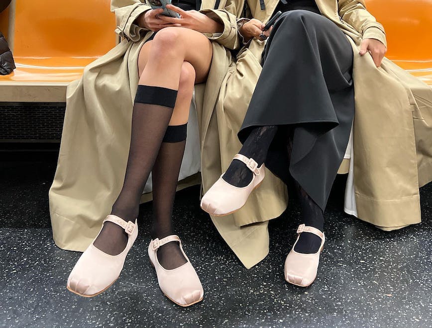 two women sitting on the subway