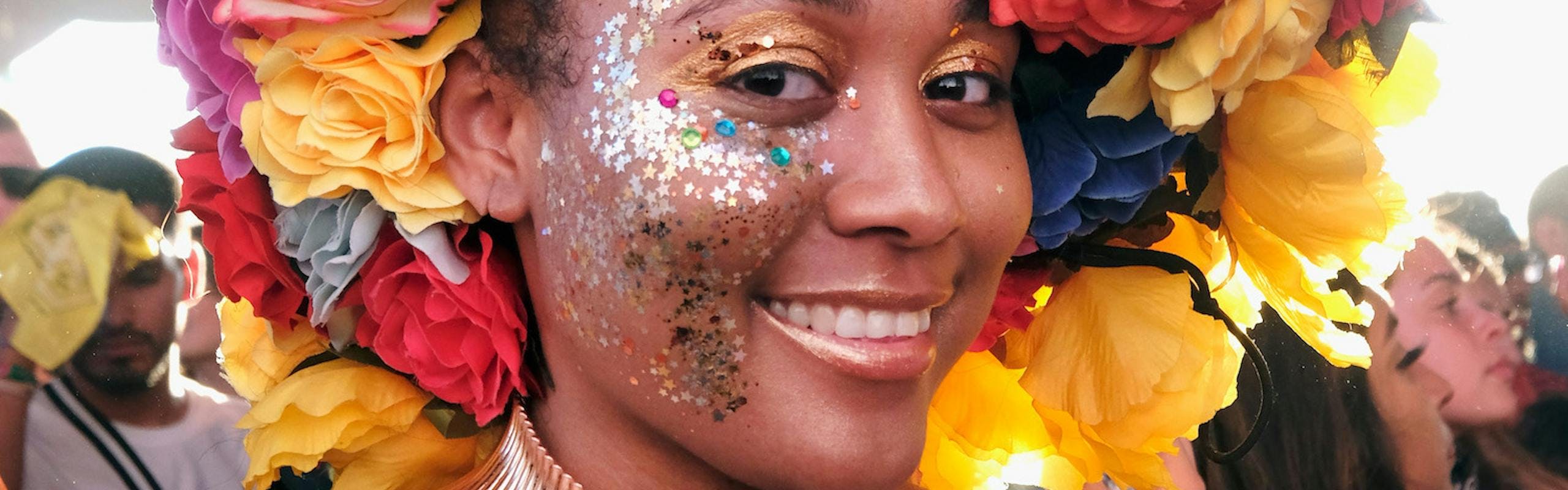 Coachella attendees with festival makeup and a colorful flower hat