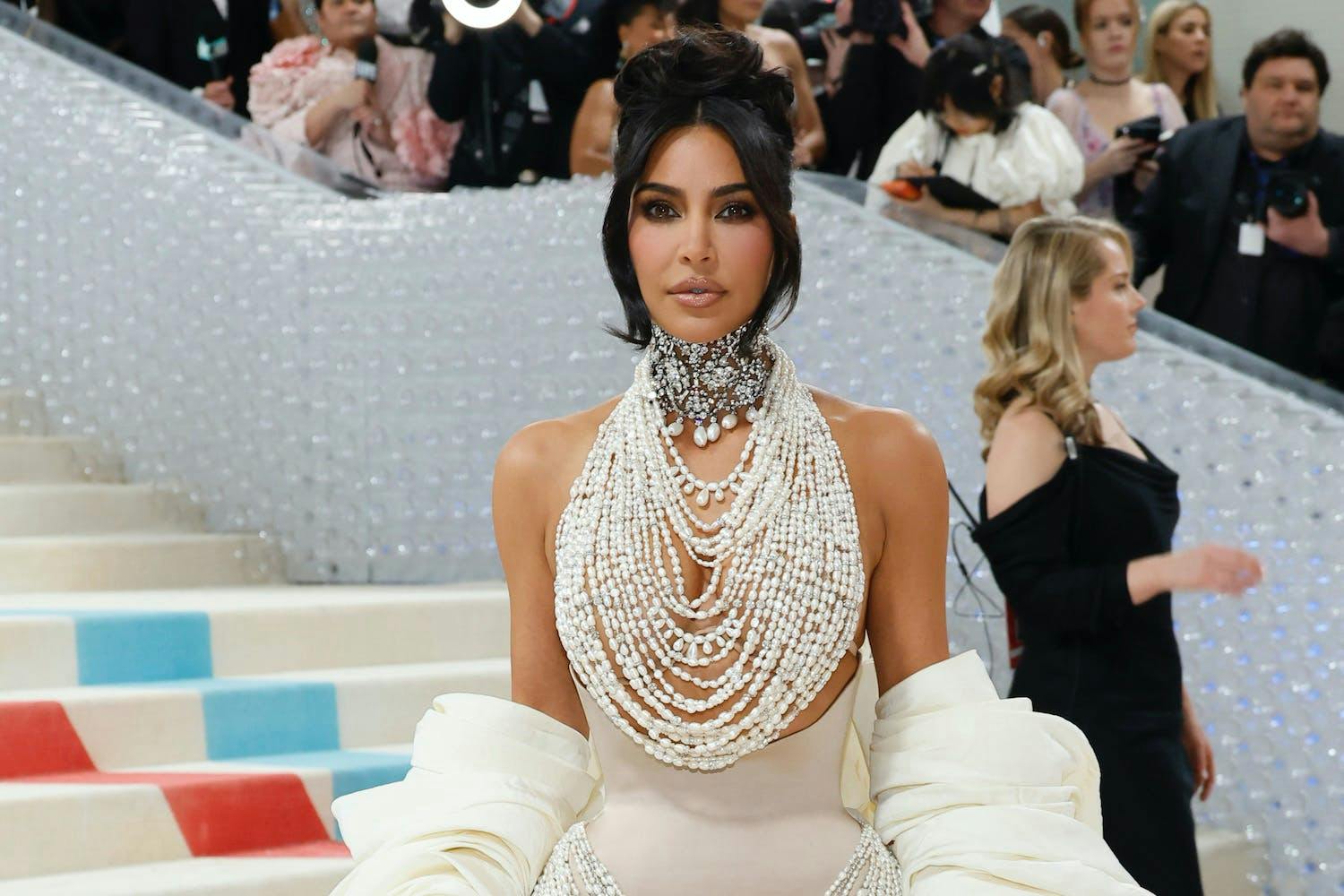 Kim kardashian in pearl dress at 2023 Met gala.