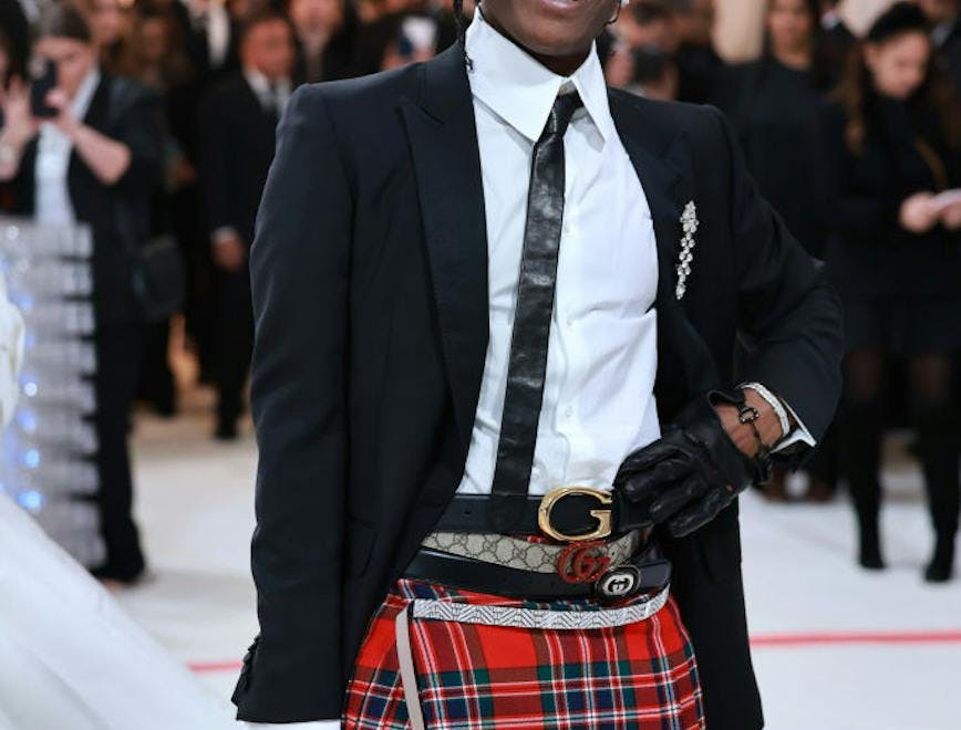 ASAP Rocky in a black blazer and plaid skirt.