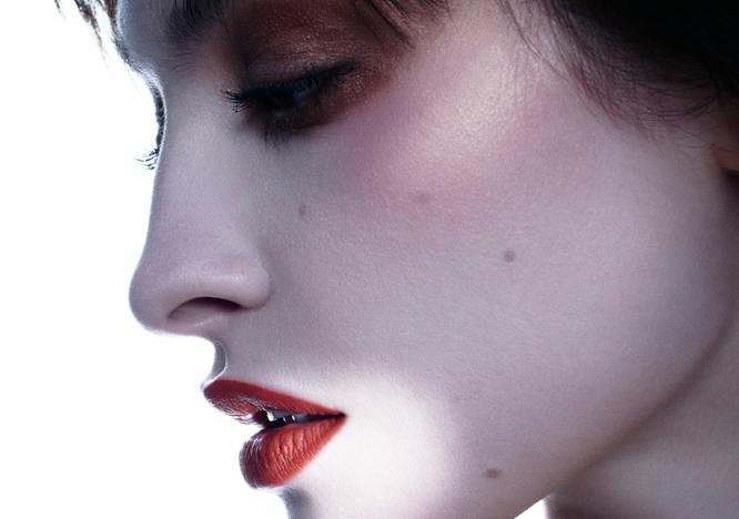 Model wearing Dior makeup in profile view.