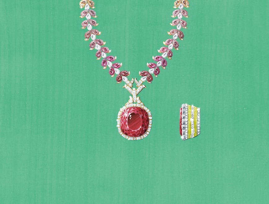 A ruby red Gucci necklace against a green backdrop.