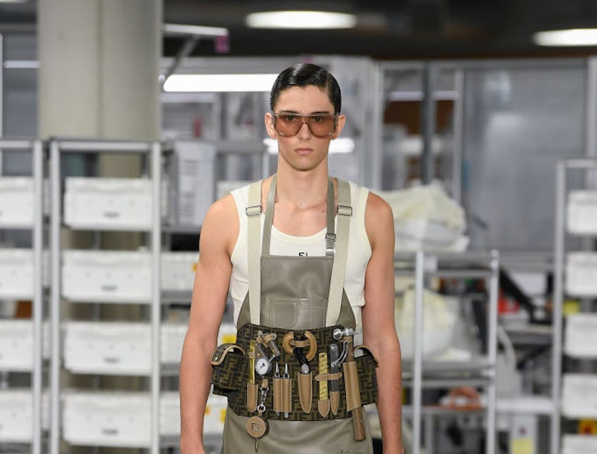A model in a jumpsuit and utility belt.
