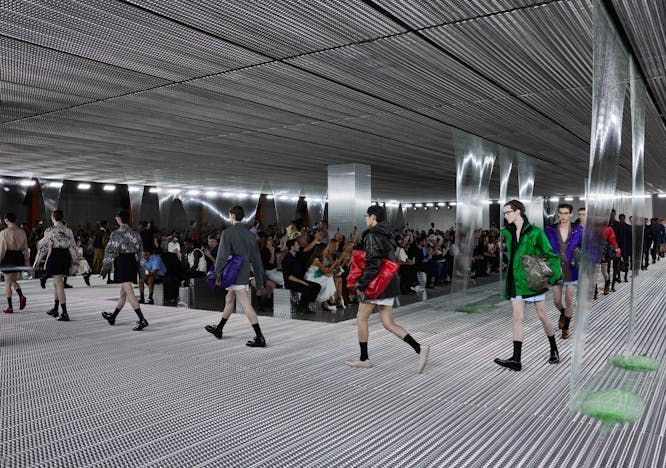 A group of models walking on the runway.