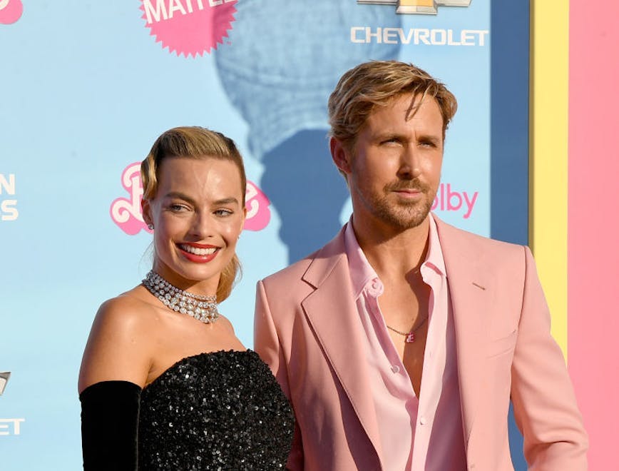 Margot Robbie in a black gown and Ryan Gosling in a pink suit at the Barbie premiere Los Angeles.