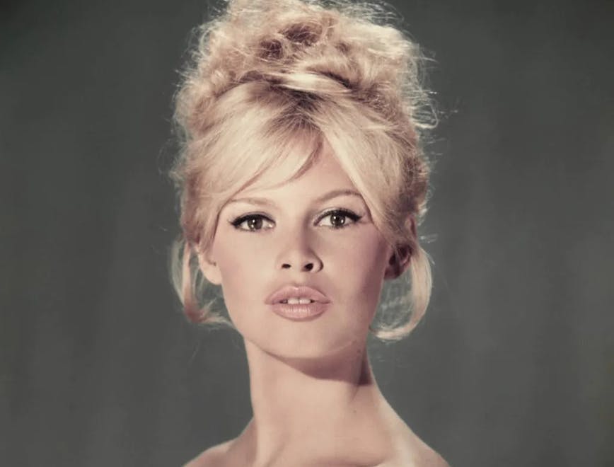 Brigitte Bardot in a green top looking at the camera; french style icons
