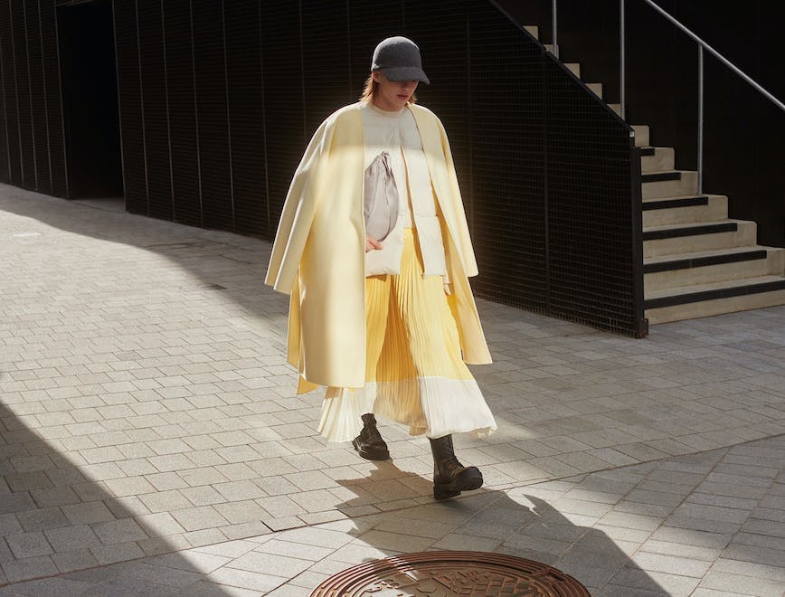 model in yellow blazer and pleated skirt from Clare Waight Keller x uniqlo collab