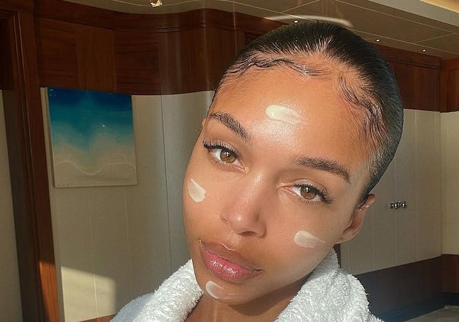 lori harvey in a white robe with cleansing oil