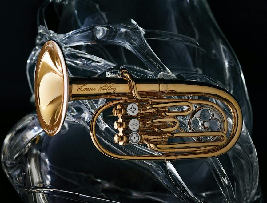 a trumpet shaped brooch against a dark backdrop