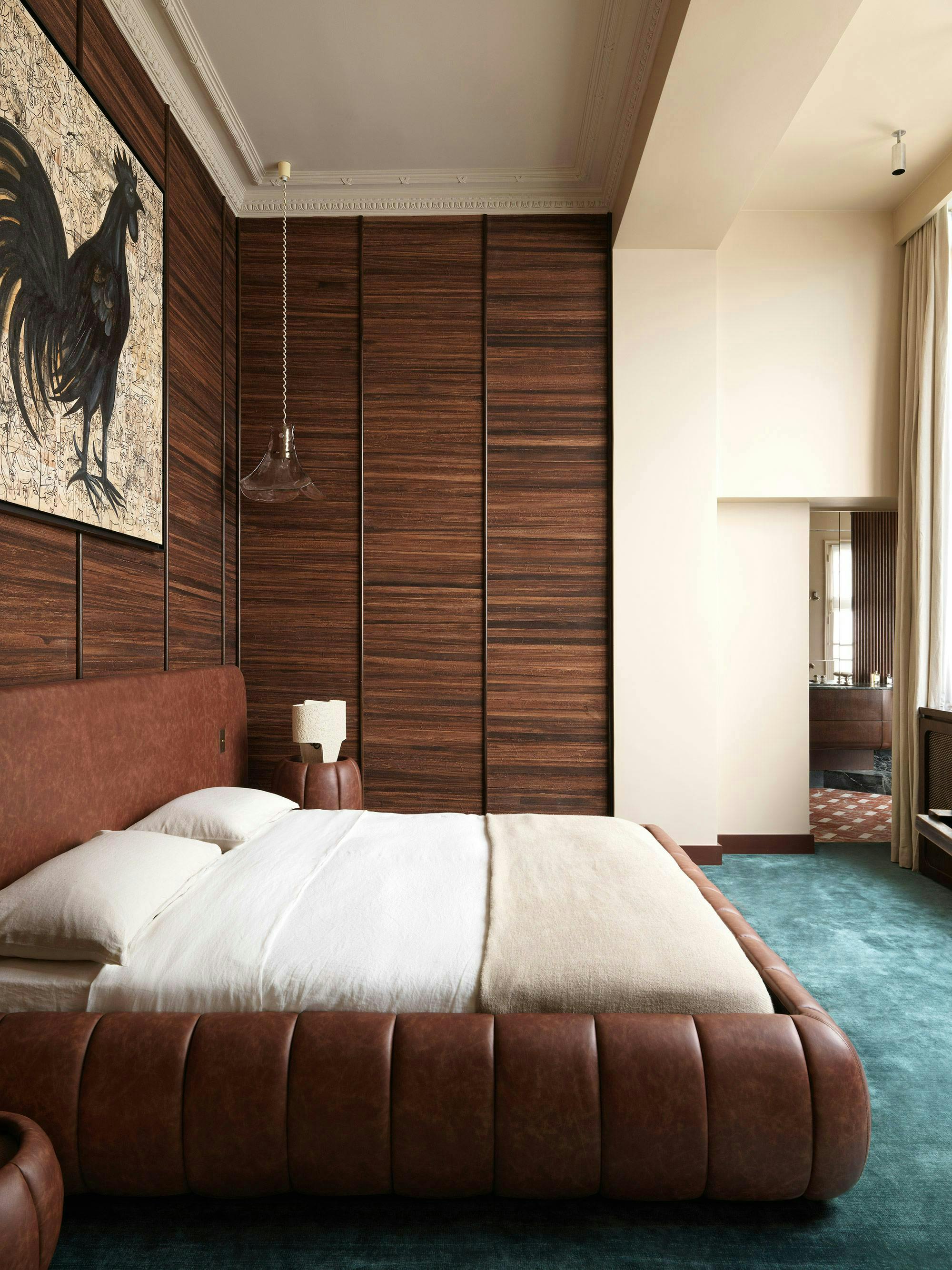 room with wood wall paneling and blue carpet