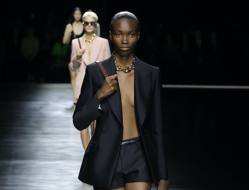 model in black blazer and black shorts