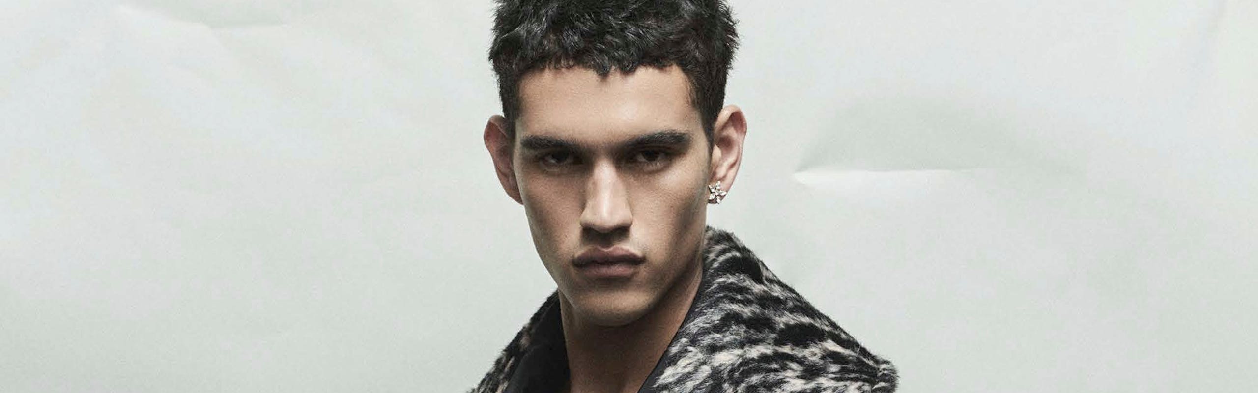 a model in a camel coat lined with grey and black print fur