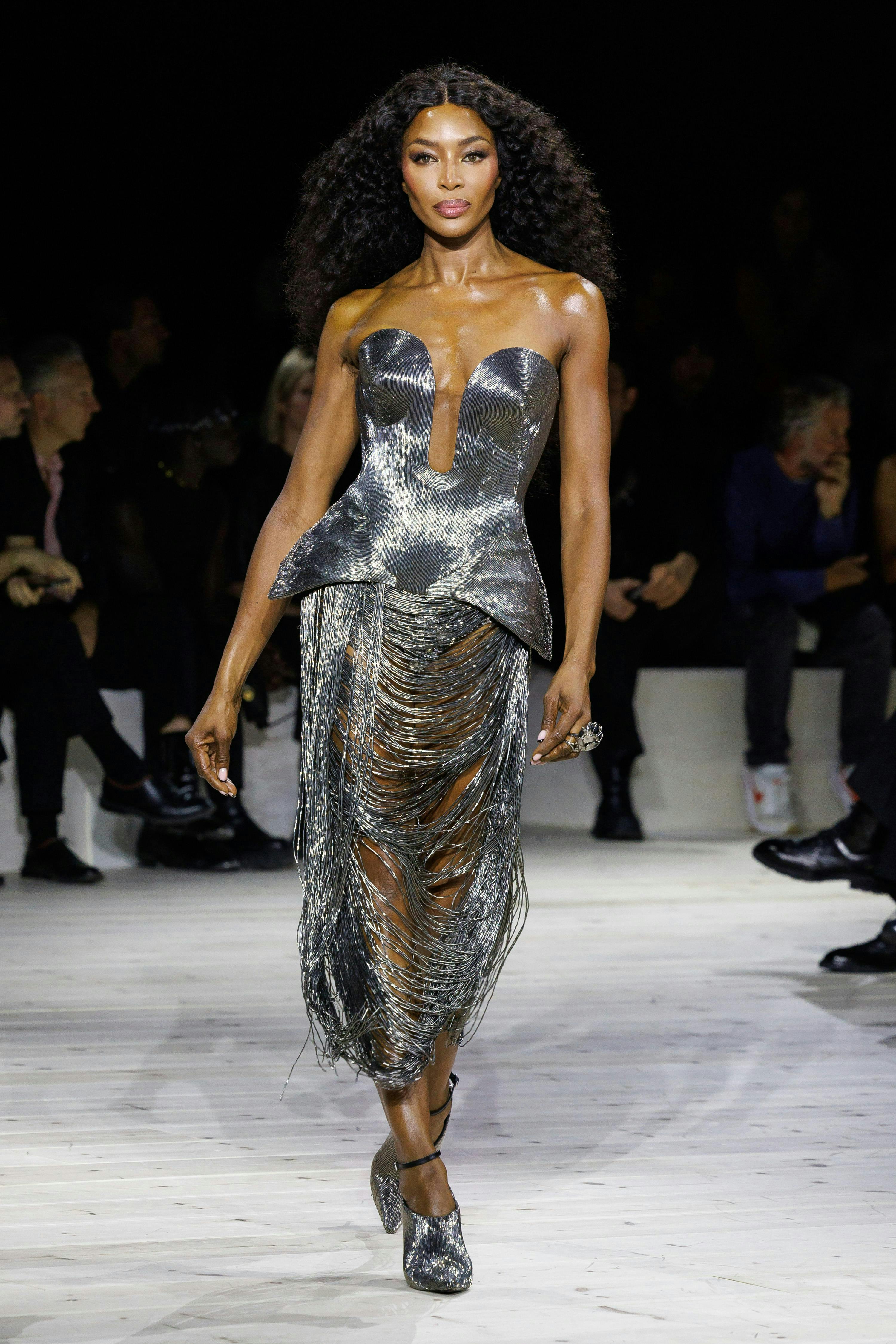 naomi campbell in a silver peplum bodice and fringe skirt
