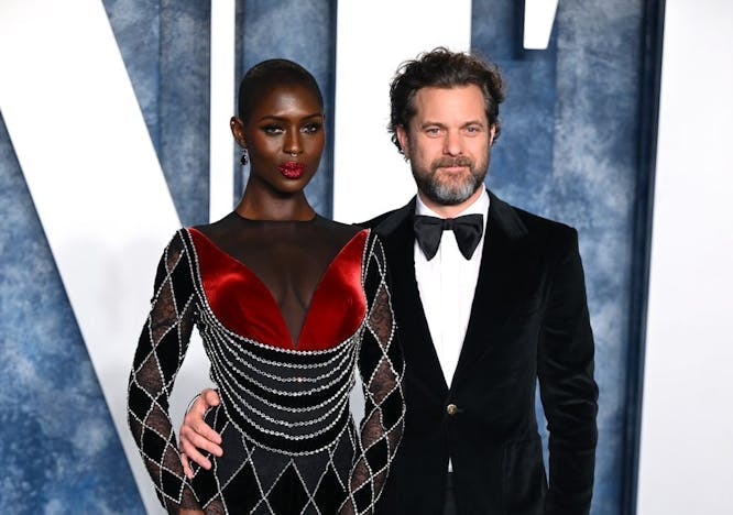 jodie turner smith in a red and black sheer dress next to joshua jackson