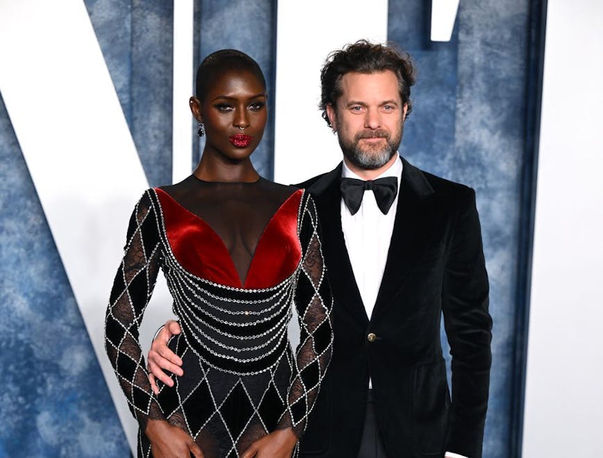 jodie turner smith in a red and black sheer dress next to joshua jackson