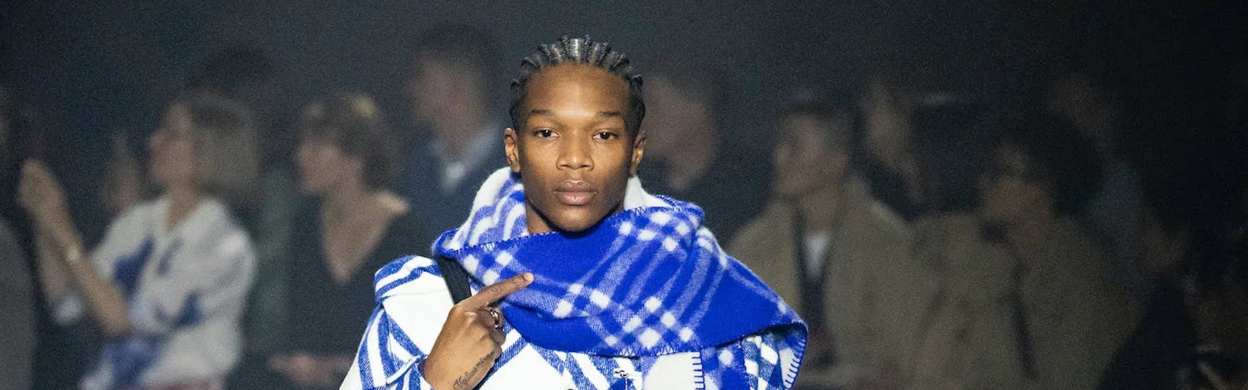 a model in blue plaid cashmere scarf and matching top and pants