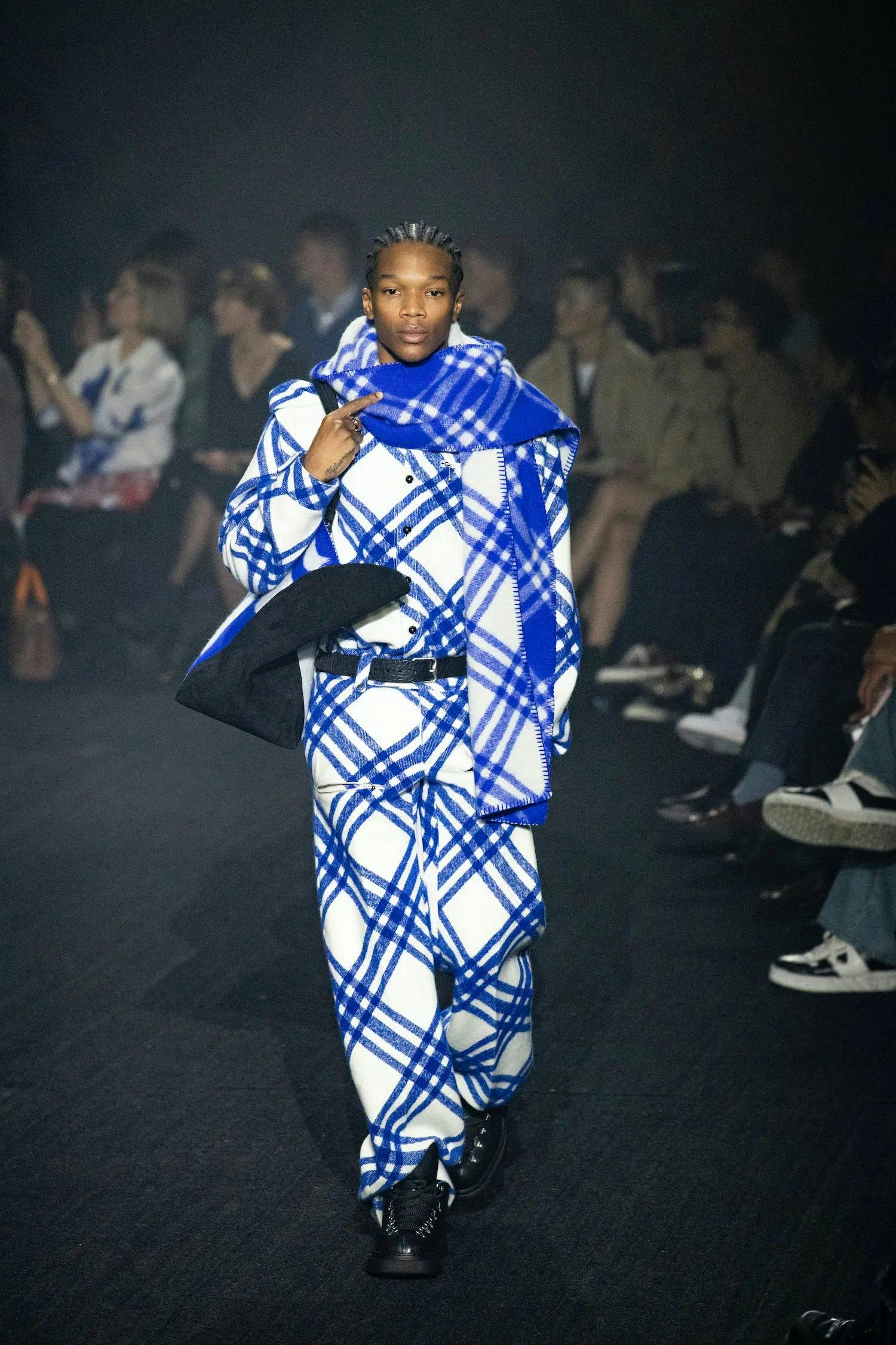 a model in blue plaid cashmere scarf and matching top and pants