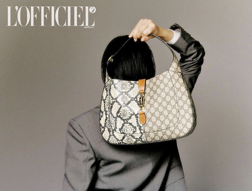 a model holding a gucci jackie bag