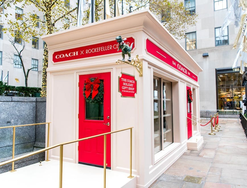 a small red and white building for coach x rockefeller holiday goft shop