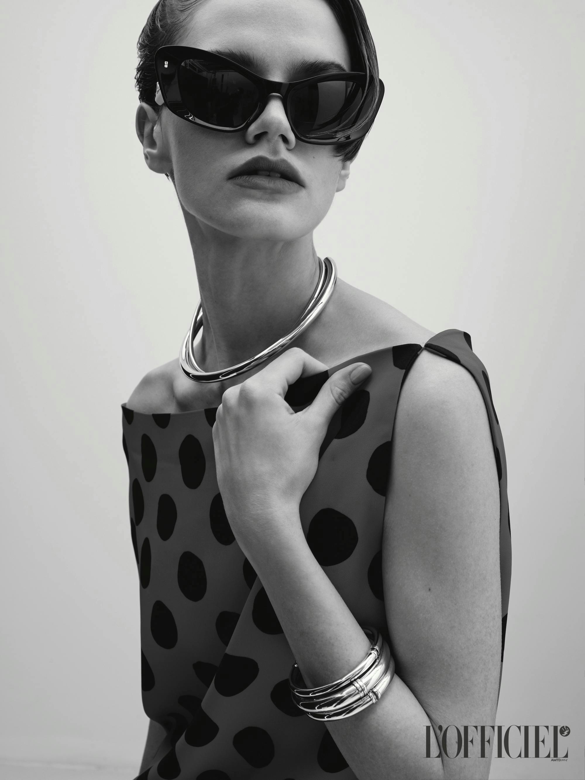 model posing wearing sunglasses, necklace and bangles