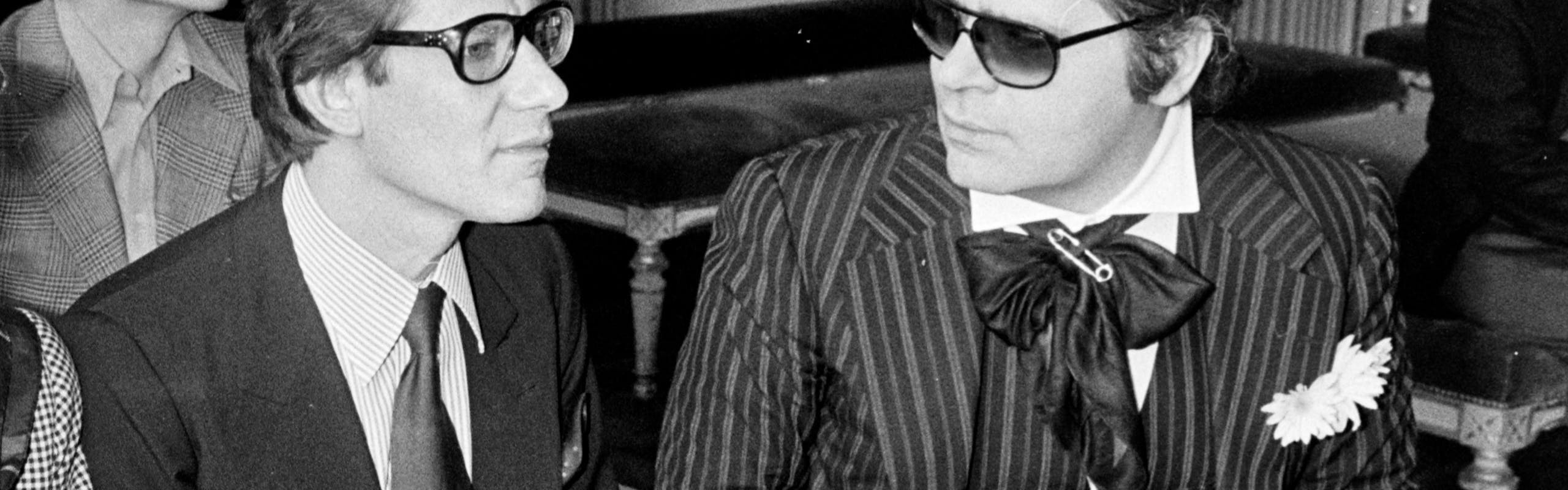 Portrait of Yves Saint Laurent and Karl Lagerfeld attending the wedding of Paloma Picasso and Rafael Lopez-Sanchez in Paris.
