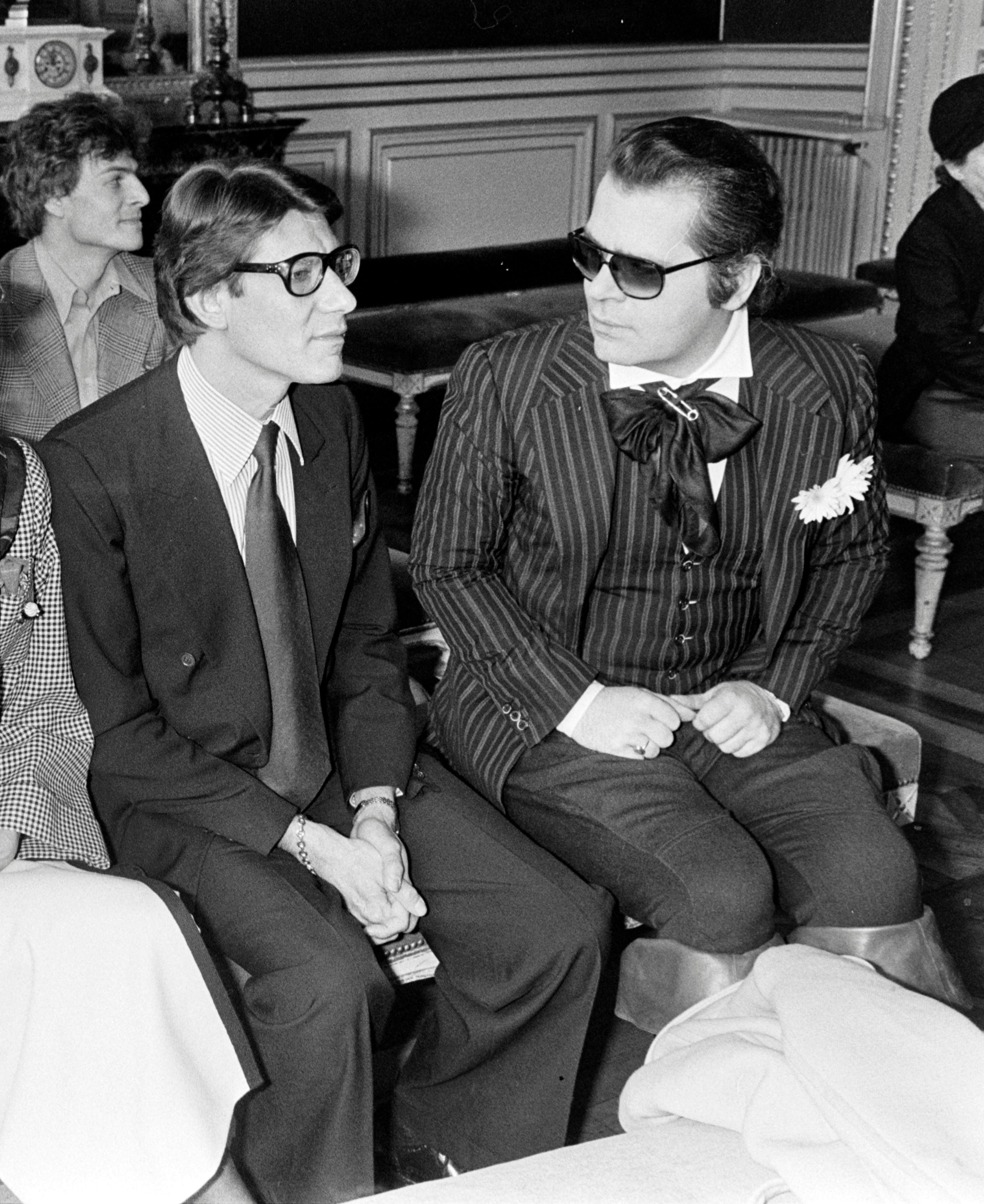 Portrait of Yves Saint Laurent and Karl Lagerfeld attending the wedding of Paloma Picasso and Rafael Lopez-Sanchez in Paris.
