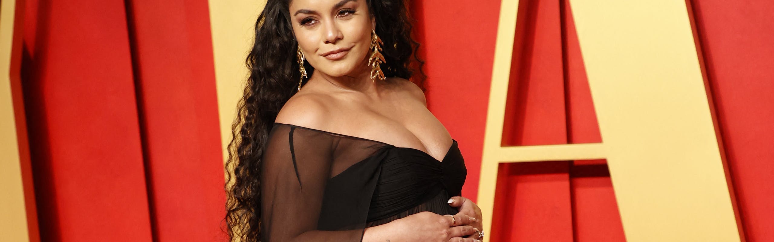 celebrity pregnancy announcements 2024: vanessa hudgens at the 2024 vanity fair oscars after party wearing a black sheer gown
