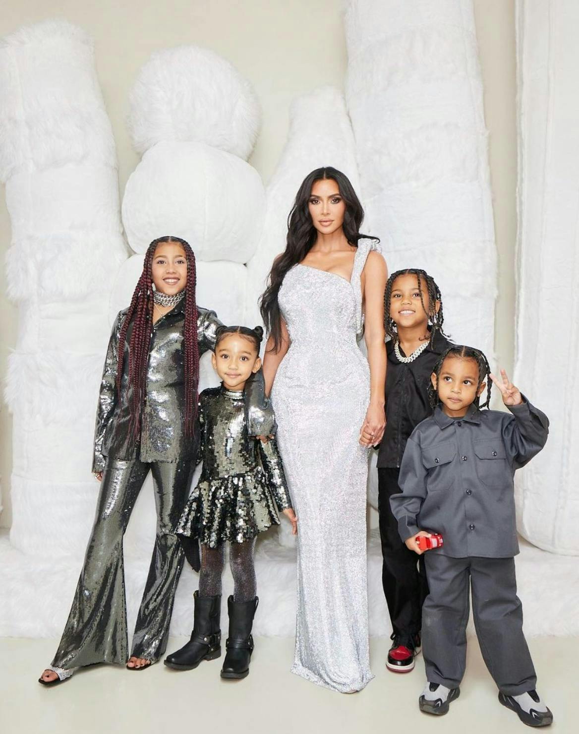unique celebrity baby names: Kim Kardashian and her children, North, Saint, Chicago, and Psalm West.